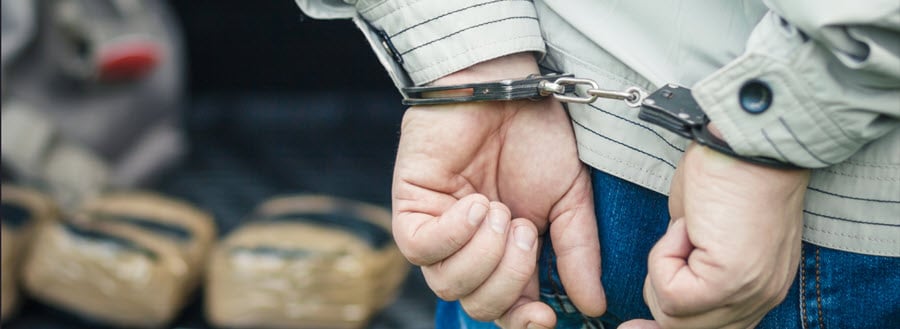 A man in handcuffs detained the transportation of drugs